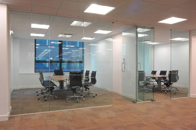 Glass-walled meeting room in an open-plan office