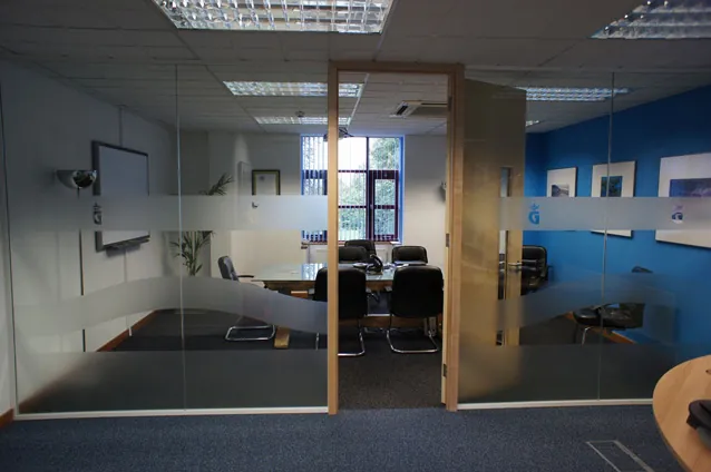 Glazed office partitions with frosted manifestation and a timber door